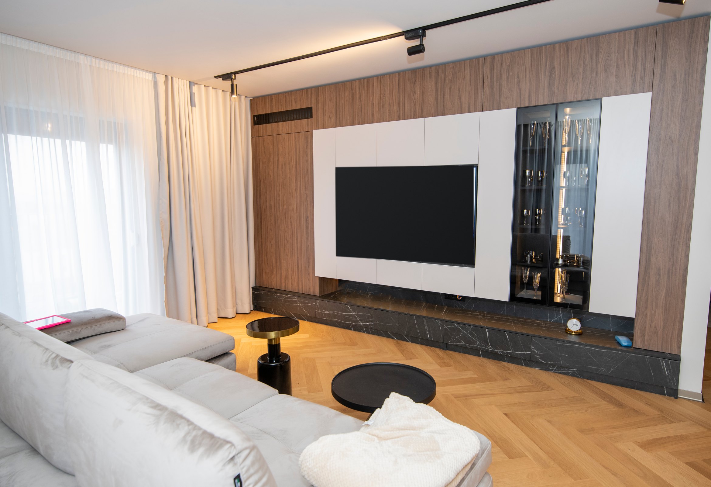 Living cu perete TV din nuc și soclu cu aspect de marmură